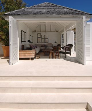 Garden room with concrete steps leading up to the room