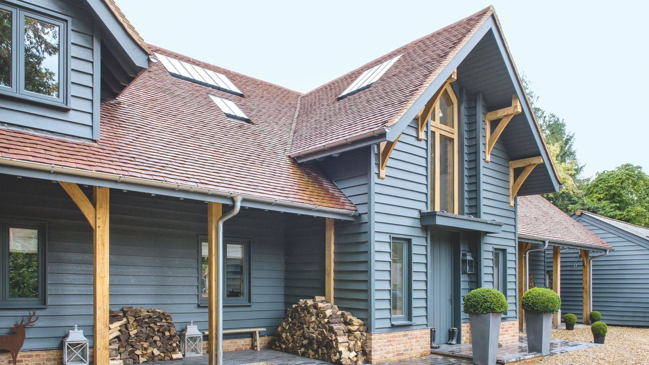 Dormer loft conversion in an oak frame bungalow with blue cladding