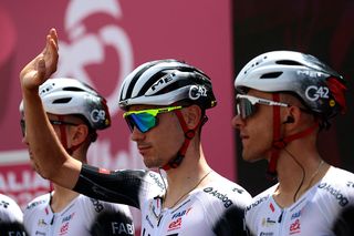 UAE Team Emirates XRG's Spanish rider Juan Ayuso waves during the presentation prior to the 3th stage of the 108th Giro d'Italia cycling race 160kms from Vlore to Vlore in Albania on May 11, 2025. (Photo by Luca Bettini / AFP)