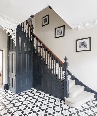 blue grey renovated staircase in period house with patterned floor tiles