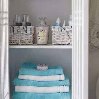 bathroom with folded fluffy towels and shelves