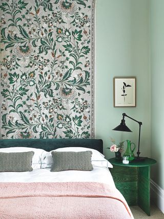 Green bedroom with a hanging fabric panel in Lewis & Wood's Coromandel linen