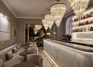 Illuminated bar with chandeliers at The Hotel Maria