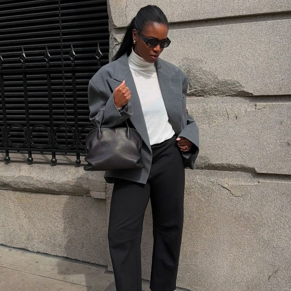 Influencer @nlmarilyn wears white derby shoes with black cigarette trousers.