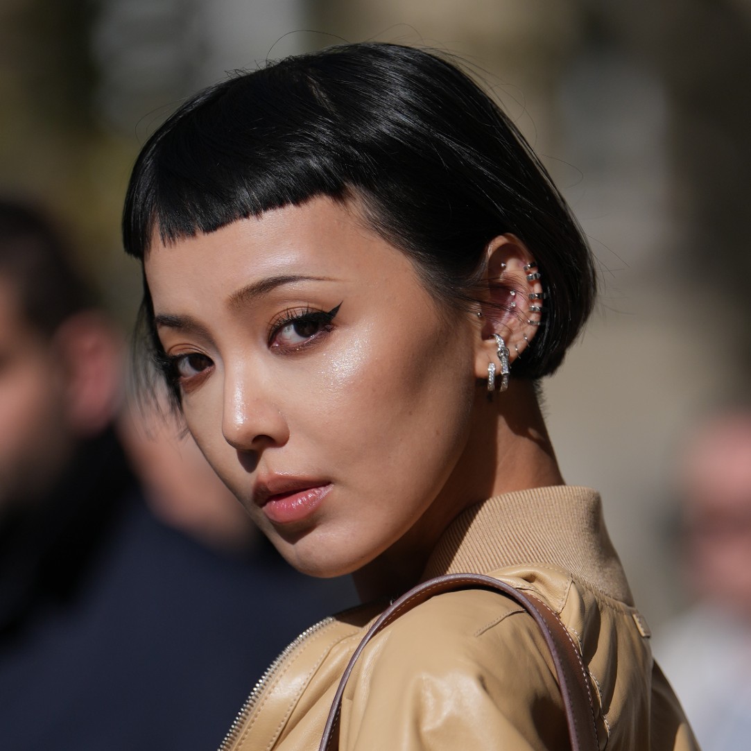 A model wearing their hair styled with micro bangs.