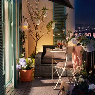 small pendant lights handing from a beautifully decorated balcony, with city views