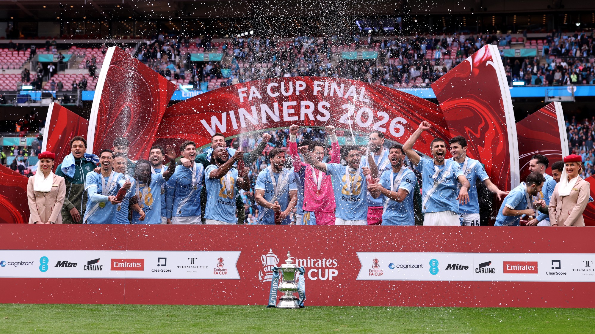 Man City players celebrate after their FA Cup victory in May