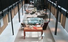 View from an upper floor looking down over seating areas with coffee tables