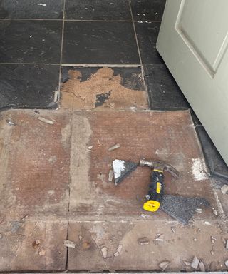 black slate tiles being removed from the floor