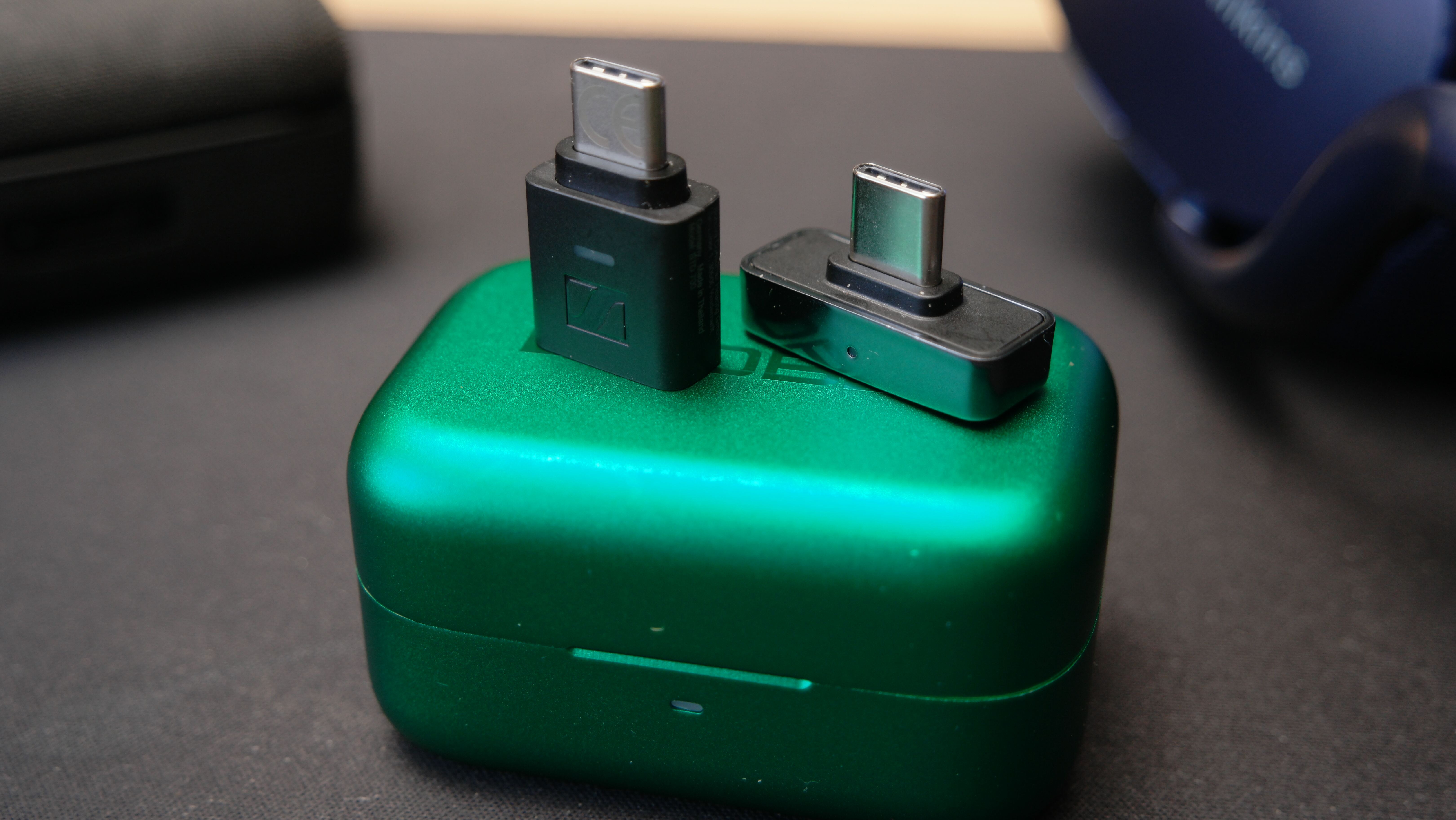 Sennheiser BTD 700 and Questyle QCC Dongle Pro sitting on top of the case of a Noble Rex5