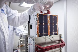 DART team engineers lift and inspect the LICIACube cubesat after it arrived at Johns Hopkins Applied Physics Laboratory (APL) in Maryland in August 2021.