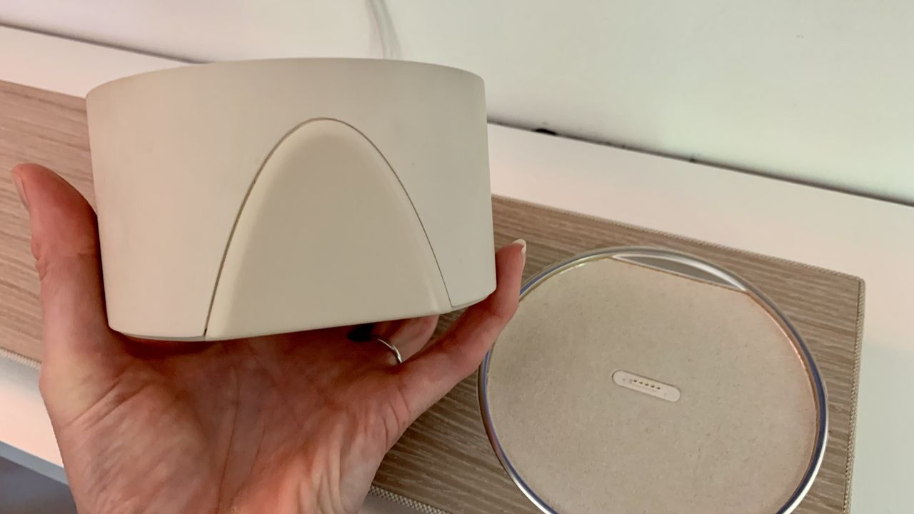 TCL Art TV soundbar's satellite speaker in a hand