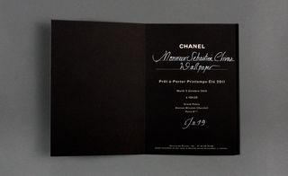 Inside view of ﻿Chanel's invitation pictured against a grey background