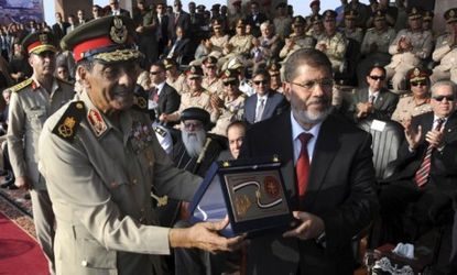 Egyptian President Mohammed Morsi is presented with the military's highest honor, the "shield of Armed Forces," following his inauguration Saturday.