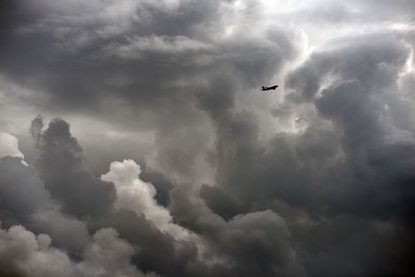 A plane flies through a storm.