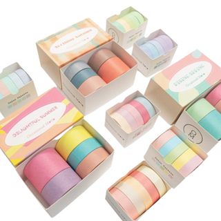 Multiple boxes of pastel colored washi tape