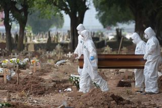 In Rio de Janeiro, Brazil, gravediggers wearing protective gear, carry a COVID-19 victim. Brazil is now facing a major coronavirus outbreak, and has had the second-most coronavirus cases in the world after the U.S. Brazil has reported more than 1.3 million cases and more than 58,000 deaths, according to the latest numbers from the Johns Hopkins dashboard.