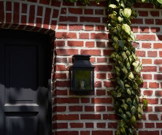 Black wall light on a brick wall