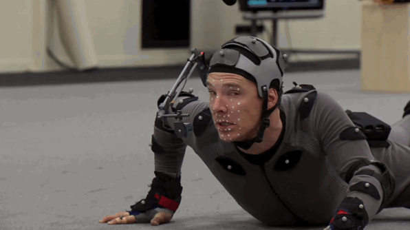 Benedict Cumberbatch wearing a motion capture suit while wriggling on the floor.