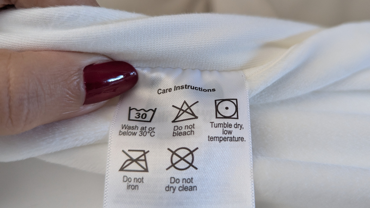 A close up shot of SquishPillow care tag