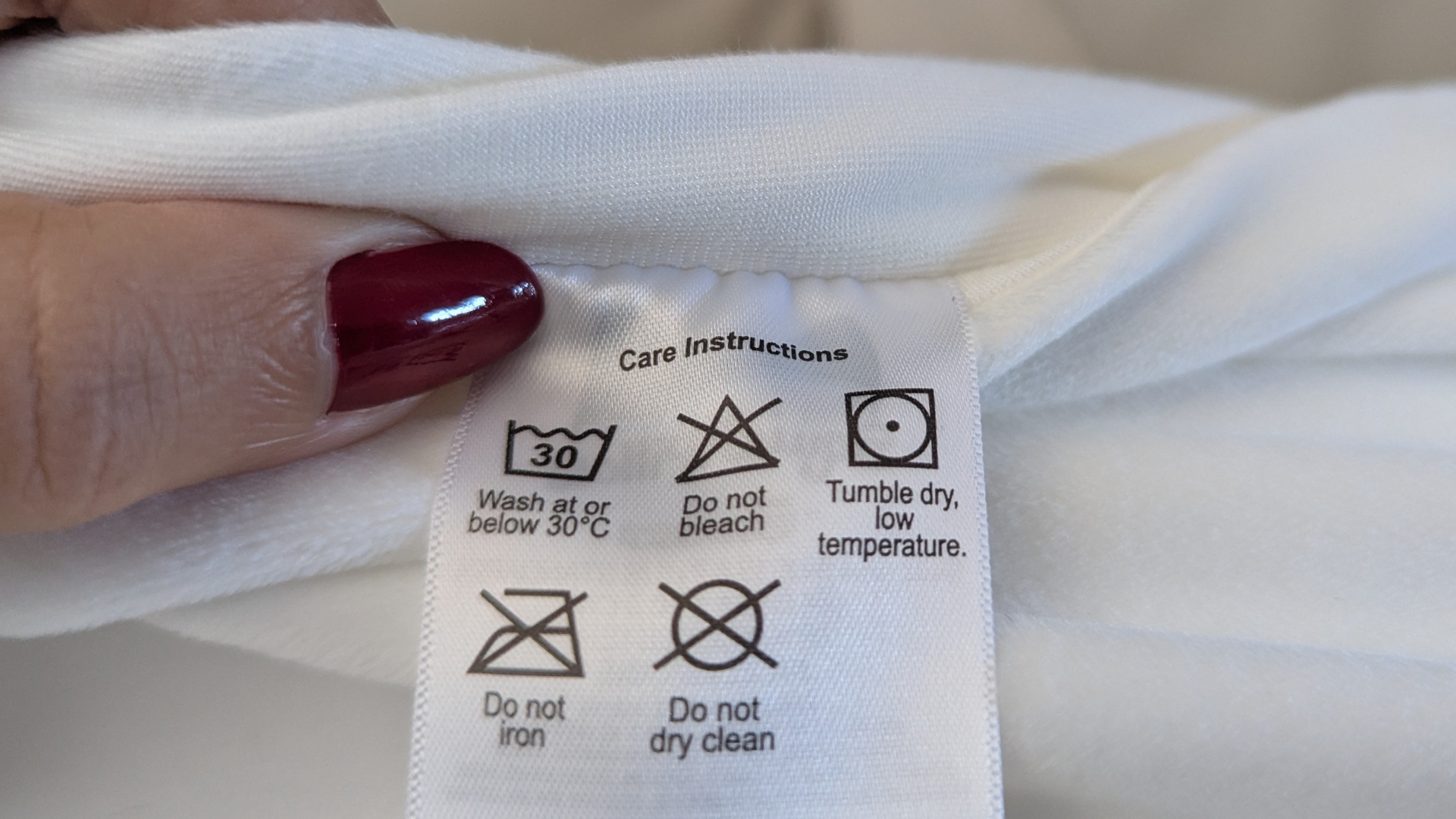 A close up shot of SquishPillow care tag