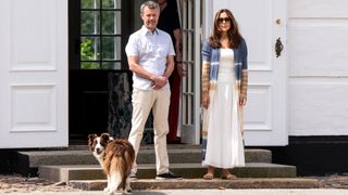 King Frederik X of Denmark and Queen Mary of Denmark wait for the arrival of the guard members before reviewing the changing of the guard in the Gråsten Castle courtyard