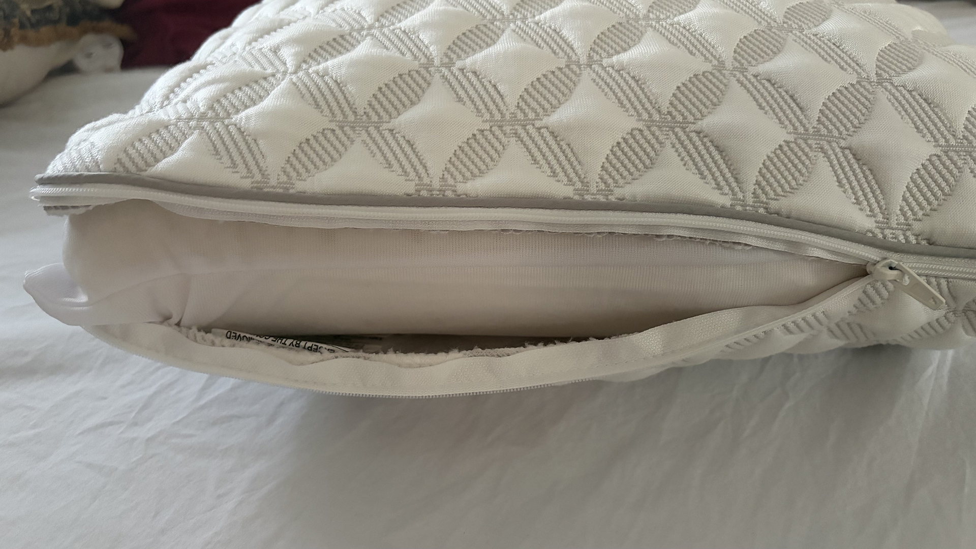 A close up on the cover of the Helix Talalay Latex pillow unzipped to show the latex foam core inside