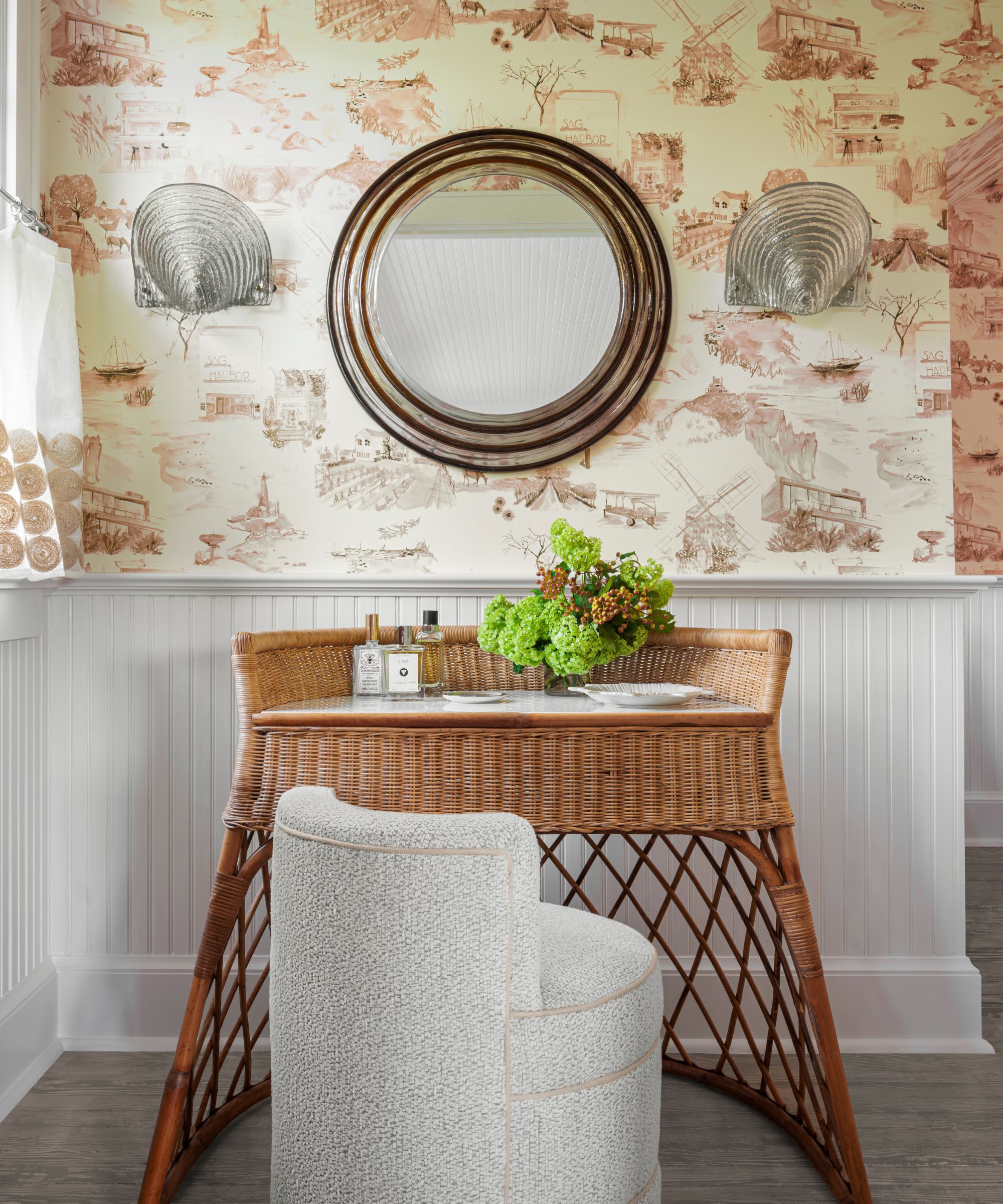 Rattan dressing table in a dressing room with wallpaper and paneling
