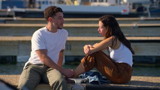 Caleb and Mariah sit on a dock outdoors, in 'The Ultimatum.'