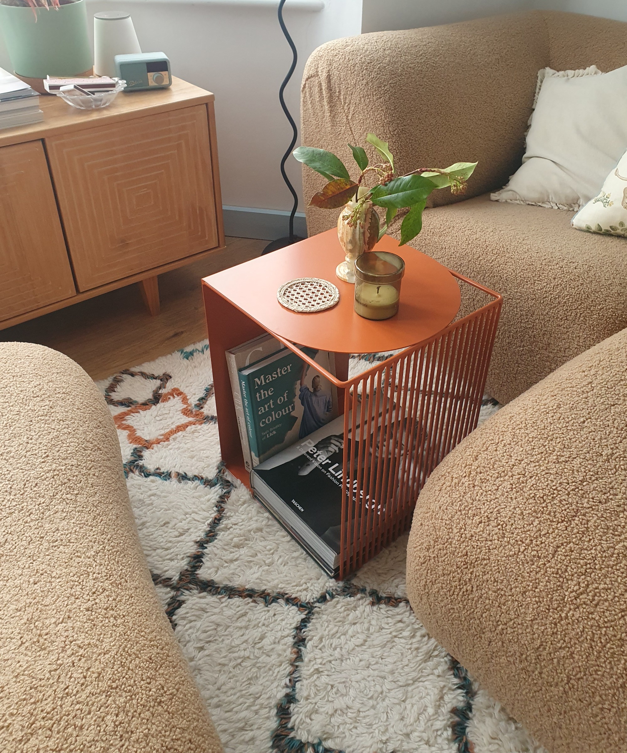 The orange La Redoute Salem side table used as a coffee table in my living area, placed on top of a wool Berber-style rug