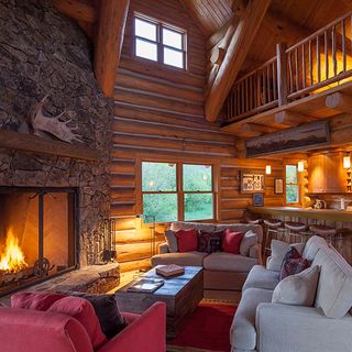 house with wooden wall fireplace and sofaset with cushions