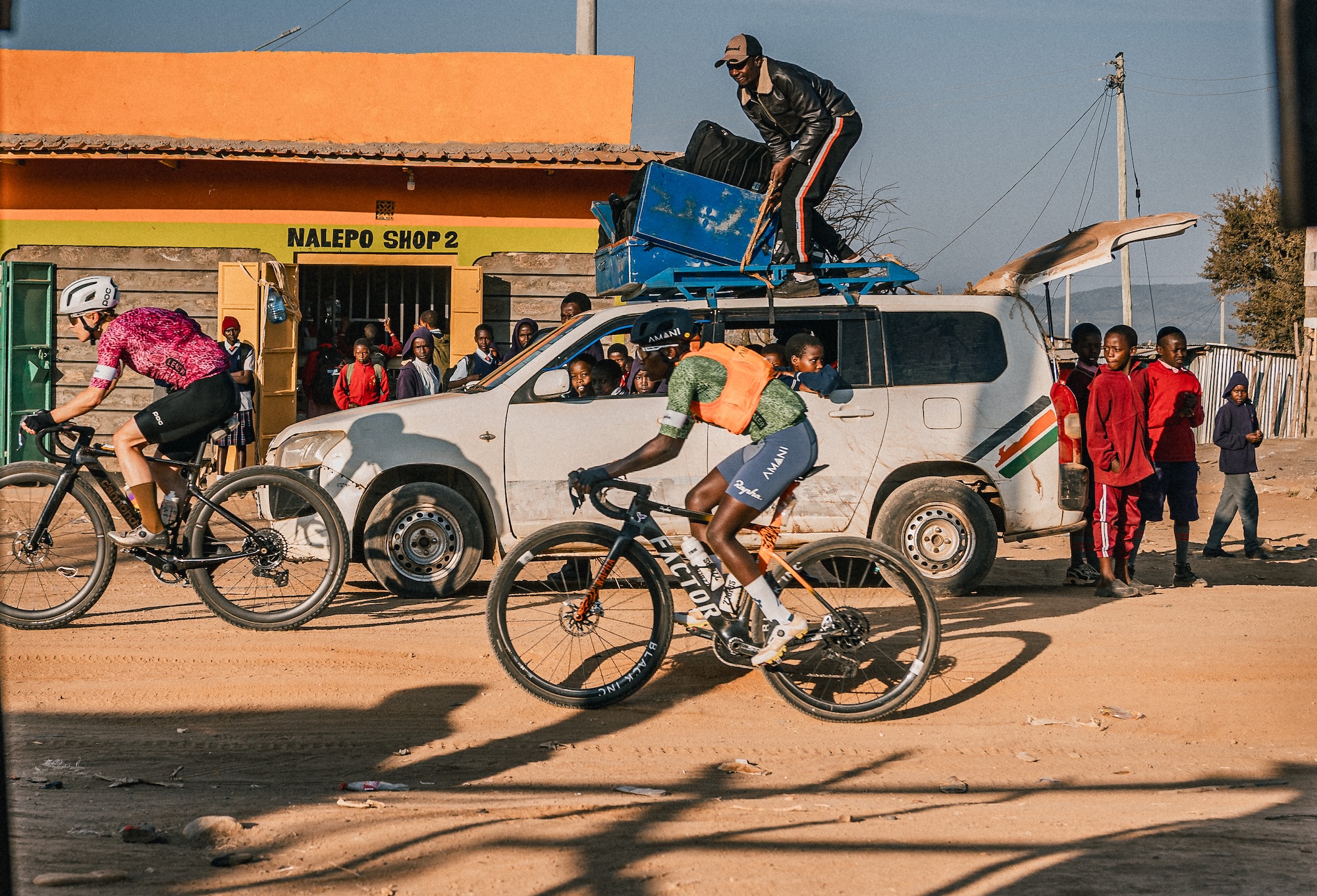 Nathalie Eklund (left) rides ahead of contender Claudette Nyirarukundo in pro women's division