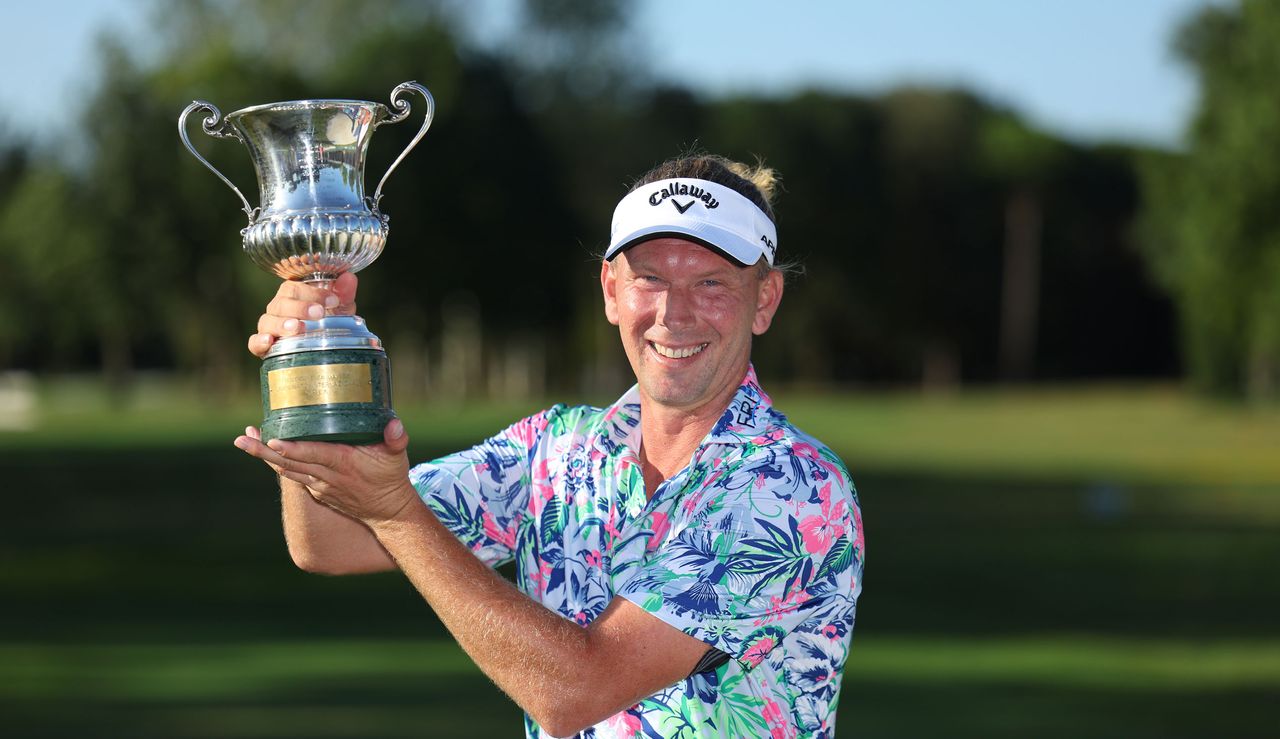 Marcel Siem holds the Italian Open trophy above his head