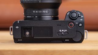 The Sony ZV-E1 camera sitting on a wooden table