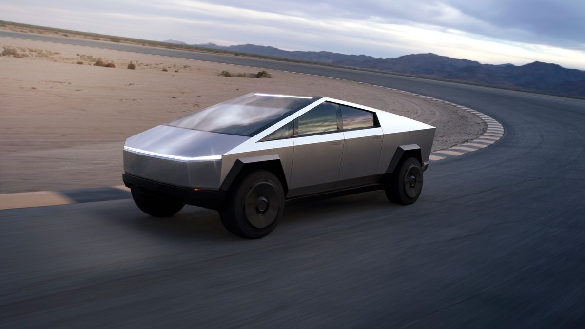 The futuristic Tesla Cybertruck driving on a racetrack in the desert