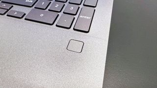 Close up of the fingerprint scanner on the keyboard deck of the Acer Chromebook Plus Enterprise 515, on a black desk against a white background.