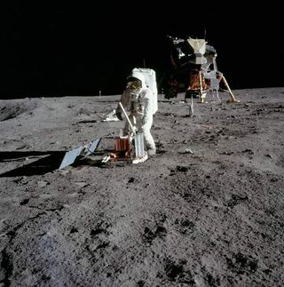 Buzz Aldrin deploys a seismometer in the Sea of Tranquility.
