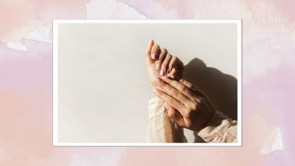 Image of hands with neutral pink nail polish on a pink watercolour background