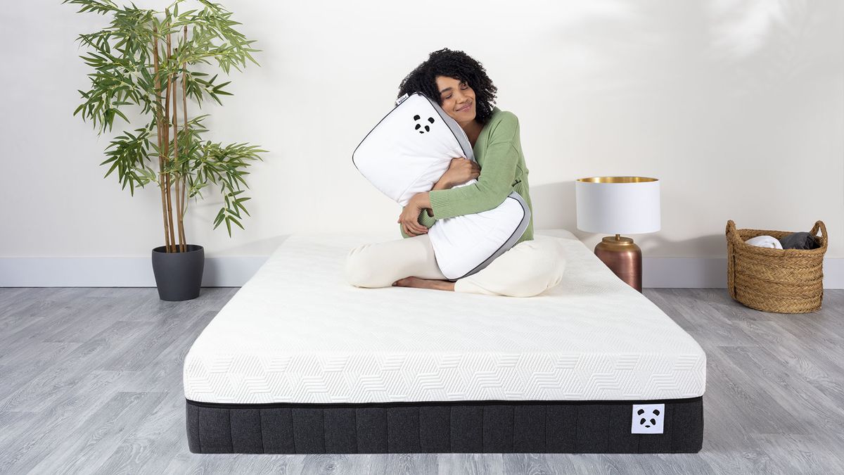 Woman on Panda mattress hugging a Panda pillow