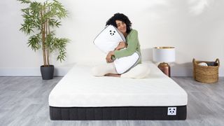 Woman on Panda mattress hugging a Panda pillow
