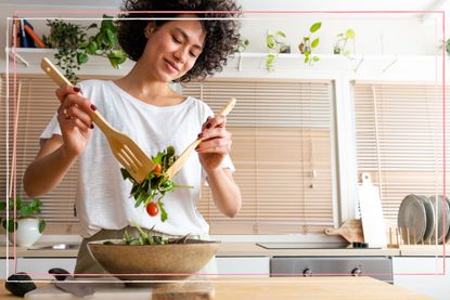 A woman tossing a salad