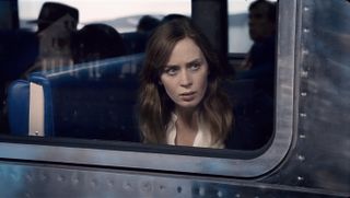 Actress Emily Blunt looking out of the window of a train, still from the movie The Girl on the Train