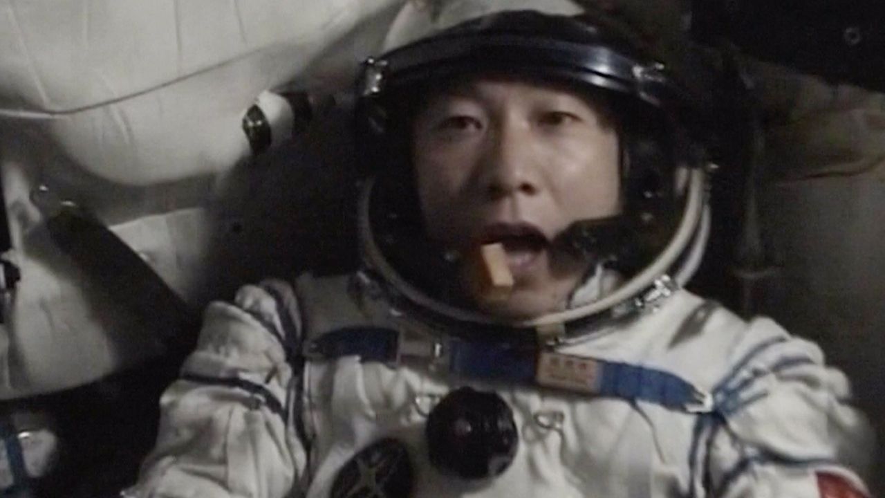A still image of a Chinese astronaut eating in space.