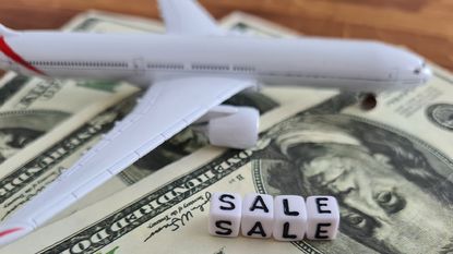 A plane on US dollars with the word sale.