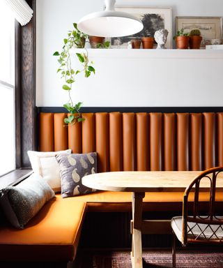 A large period window framed by leather banquette seating