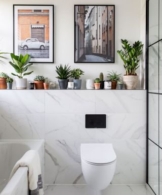bathroom with marble tiles, open shelves and plants