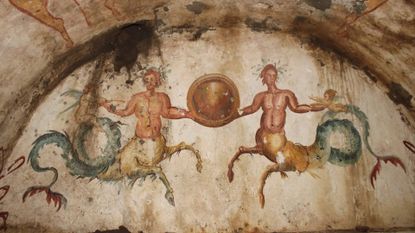 The tomb includes a painting of two ichthyocentaurs, or sea-centaurs, holding a circular shield next to two Cupid-like babies.