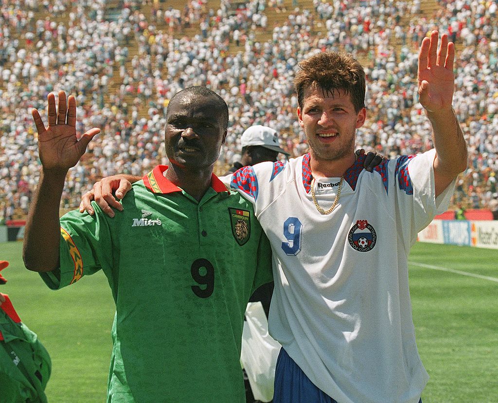 Cameroon's forward Roger Milla (L) and Russian forward Oleg Salenko wave to the crowd after setting records in their Soccer World Cup match 28 June 1994 at Stanford stadium in San Francisco. Salenko scored a record 5 goals to help his team beat Cameroon 6-1, while Roger Milla, 42 years old, became the oldest player ever to score a goal in World Cup history.