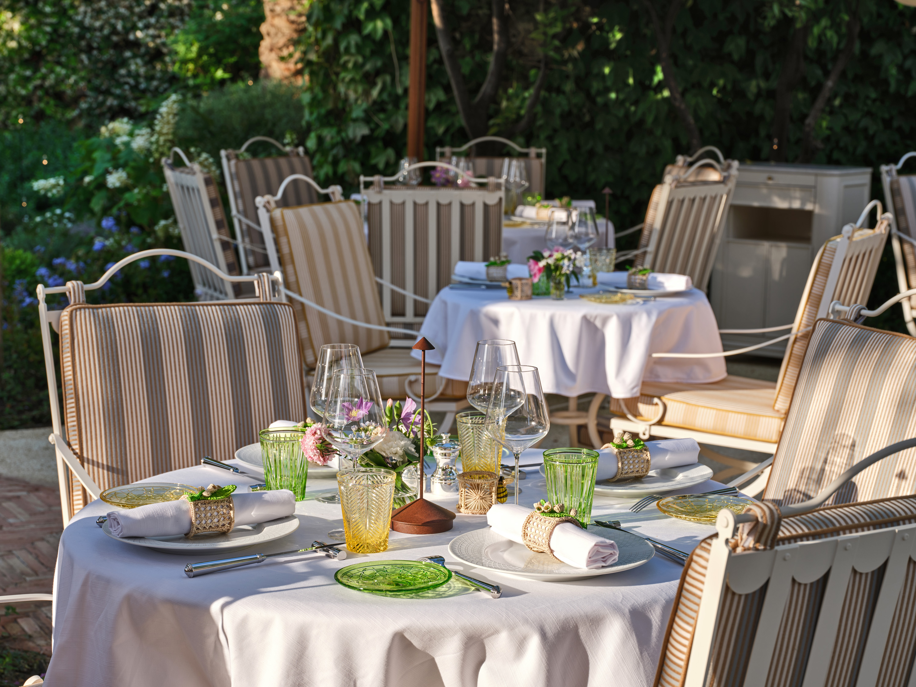 view of the new dior restaurant in saint tropez, an outdoor experience defined by haute couture flavours and lush greenery