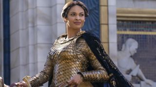 Cynthia Addai-Robinson riding horseback in gold armor in Rings of Power season 1